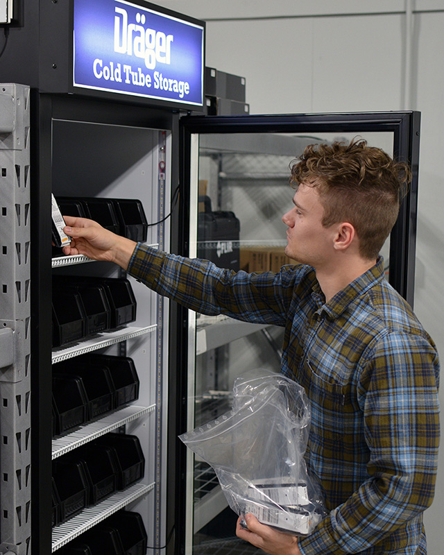 Image of person putting Draeger tubes into a cold storage freezer